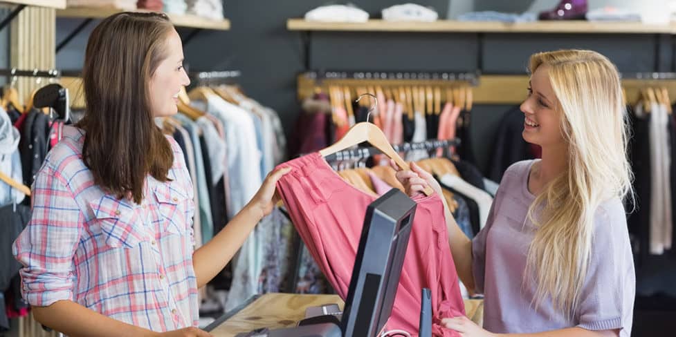 Shop assistant dealing with a customer in retail store, illustrating the concept of an active company