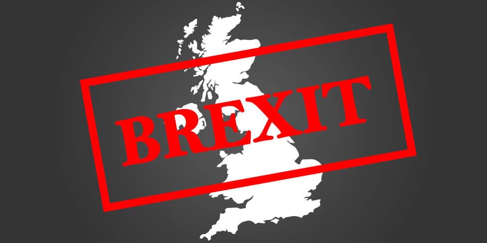 An outline of the UK against a black background with the word 'BREXIT' in red text stamped on top.