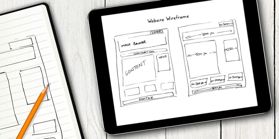 Image on an iPad displaying a hand-drawn sketch of a web page layout.