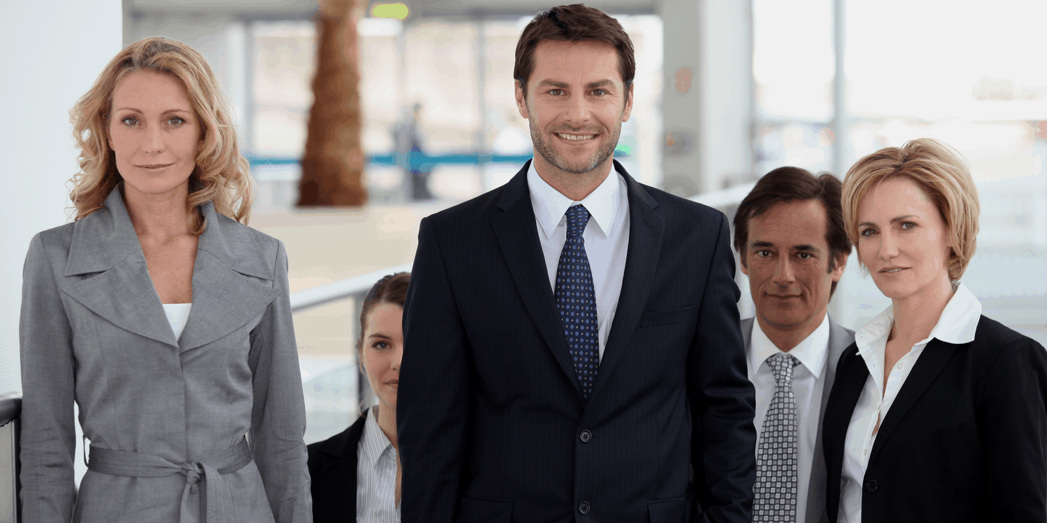 A group of male and female company directors in business suits