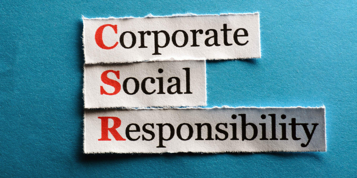Corporate Social Responsibility headlines on strips of paper against turquoise background.