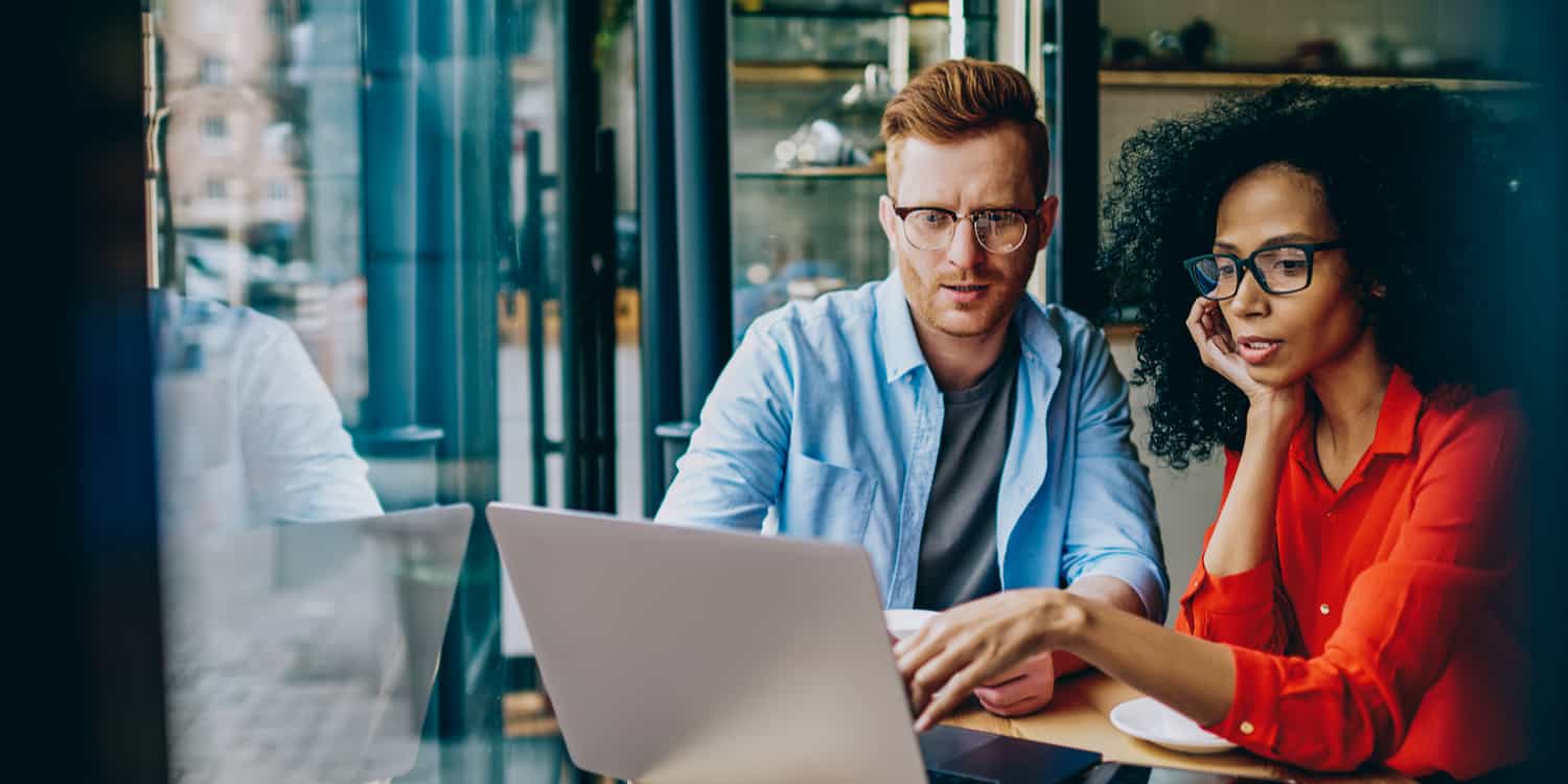 Man and woman looking at laptop