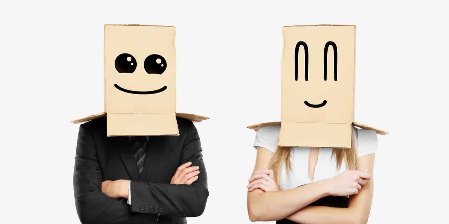 Man and women in suits with cardboard boxes on their heads