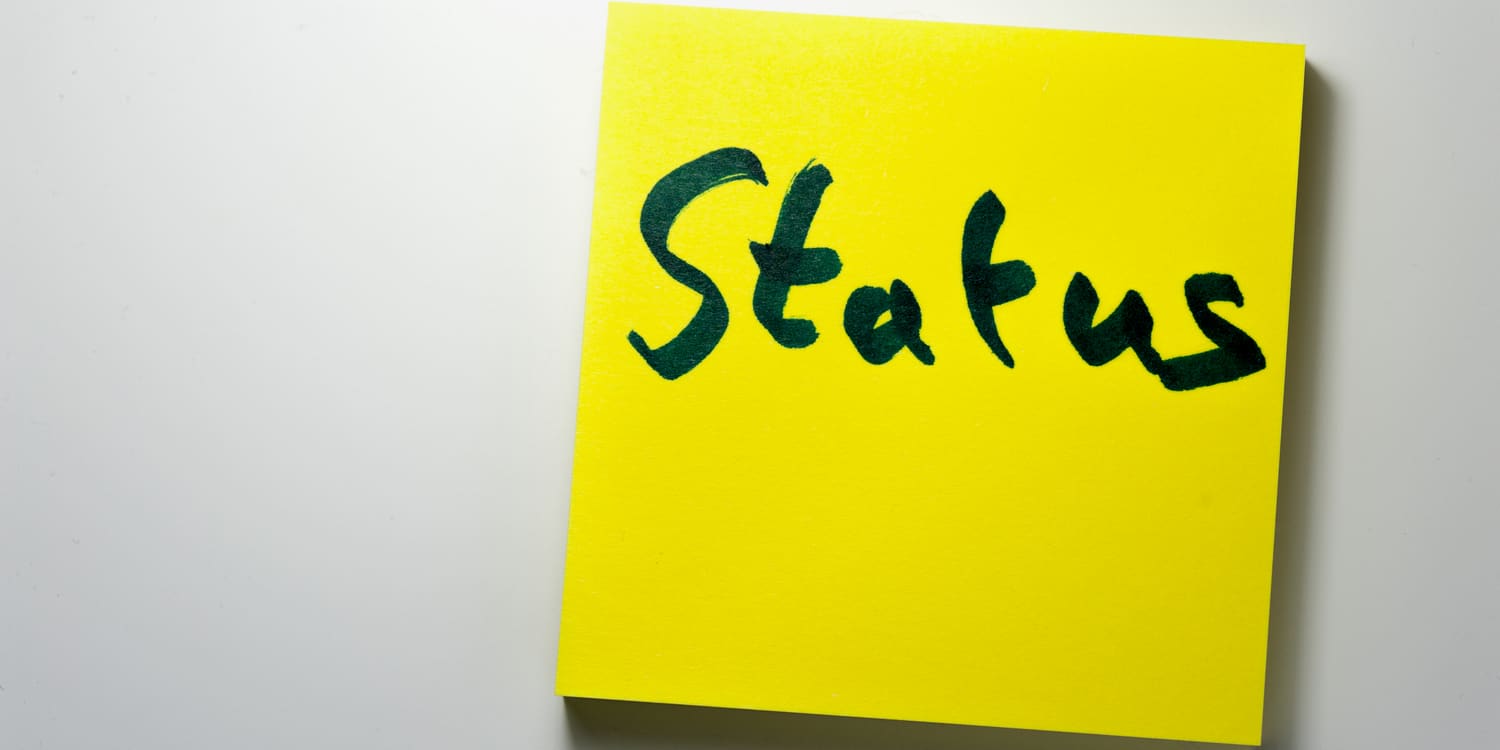 Yellow post-it note with 'Status' written on it