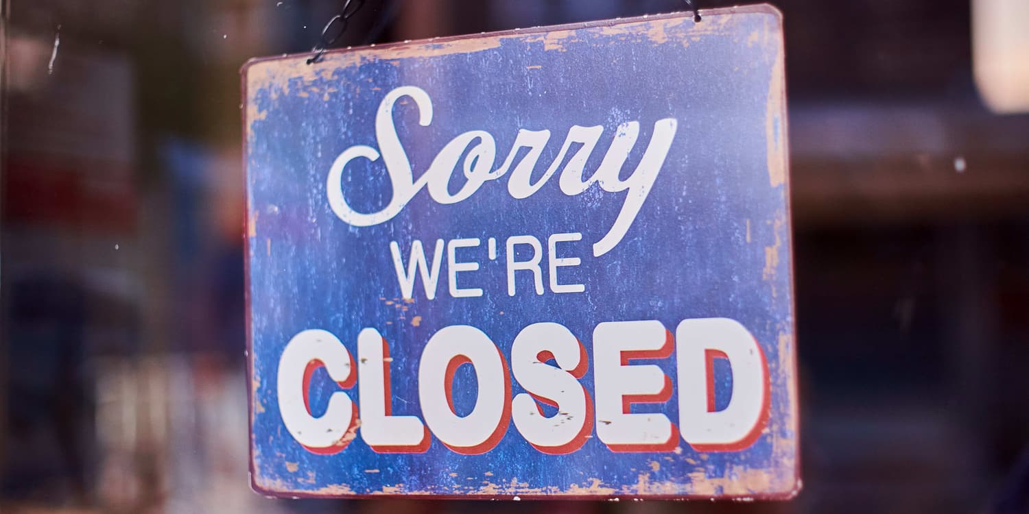 Photo of blue shop sign that says 'SORRY WE'RE CLOSED'