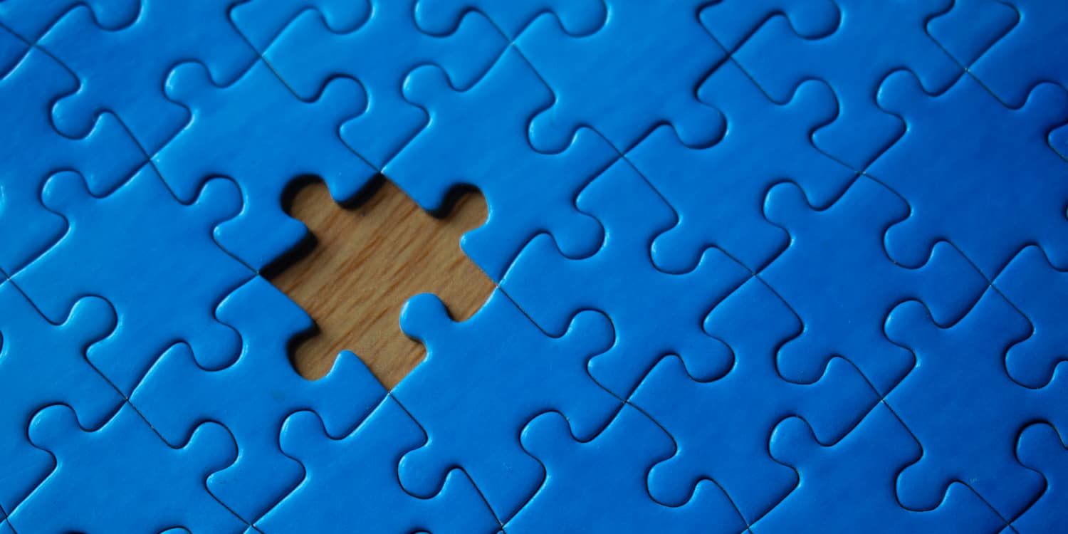 Nearly completed blue puzzle with one piece missing