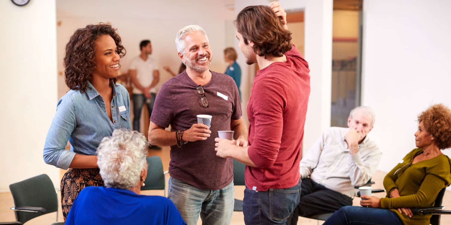 Group of people at a meeting in a community centre, illustrating the purpose of a community interest company (CIC).