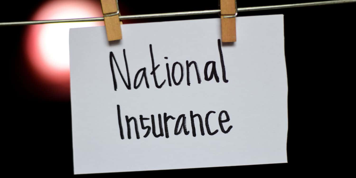 National Insurance handwriting on paper, hung with a clothes clips.