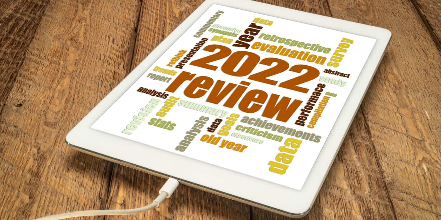 2022 year review word cloud on a digital tablet, end of year company formation analysis concept.