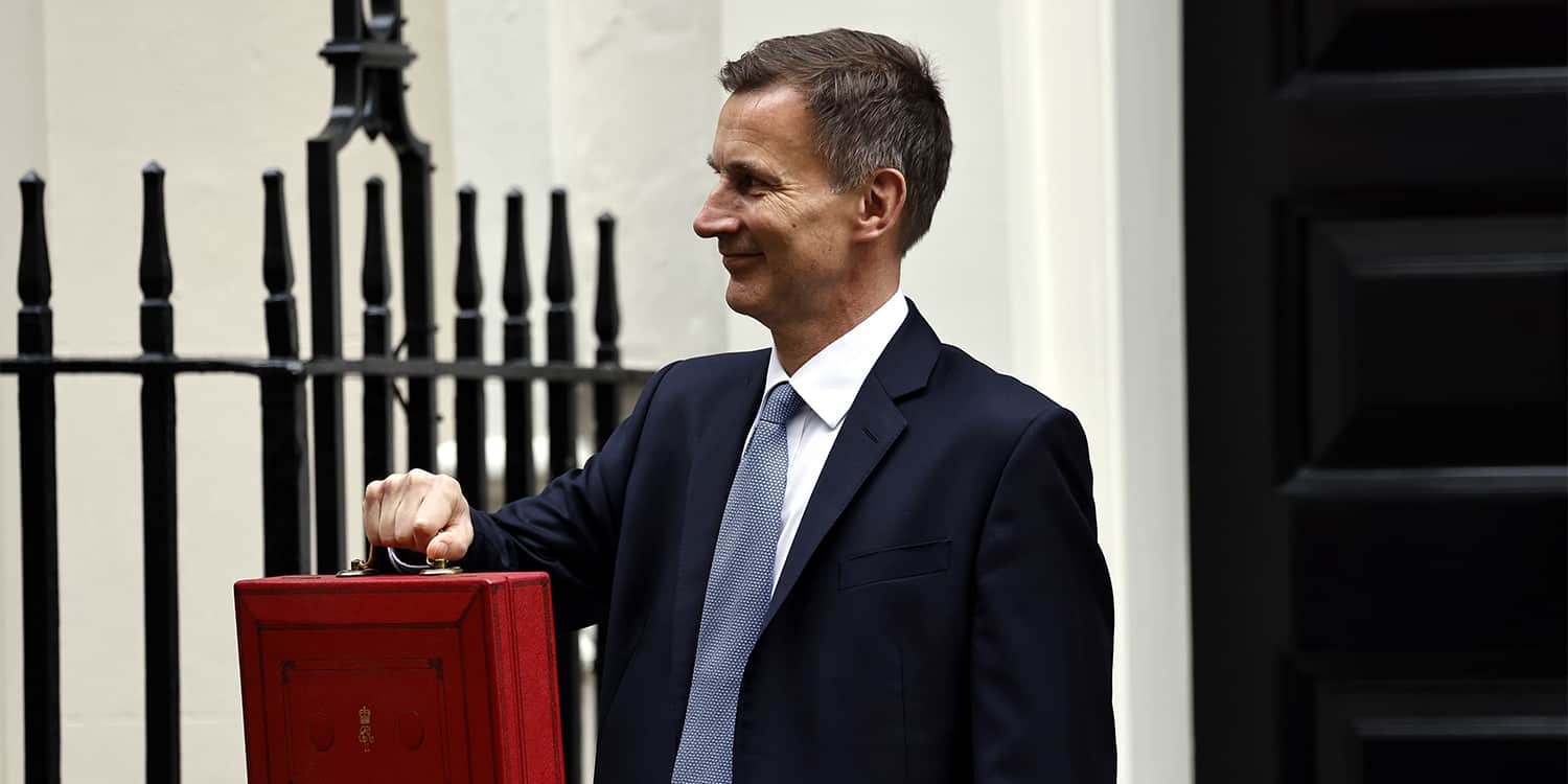 Photograph of Jeremy Hunt, Chancellor of the Exchequer, holding the red 'Budget Box'