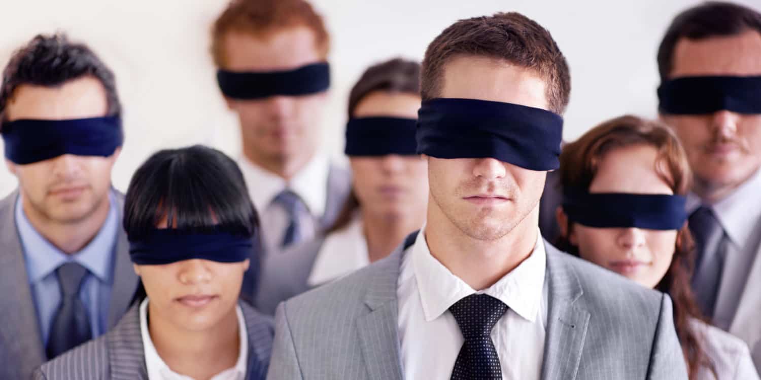 A group of businesspeople all wearing black blindfolds.