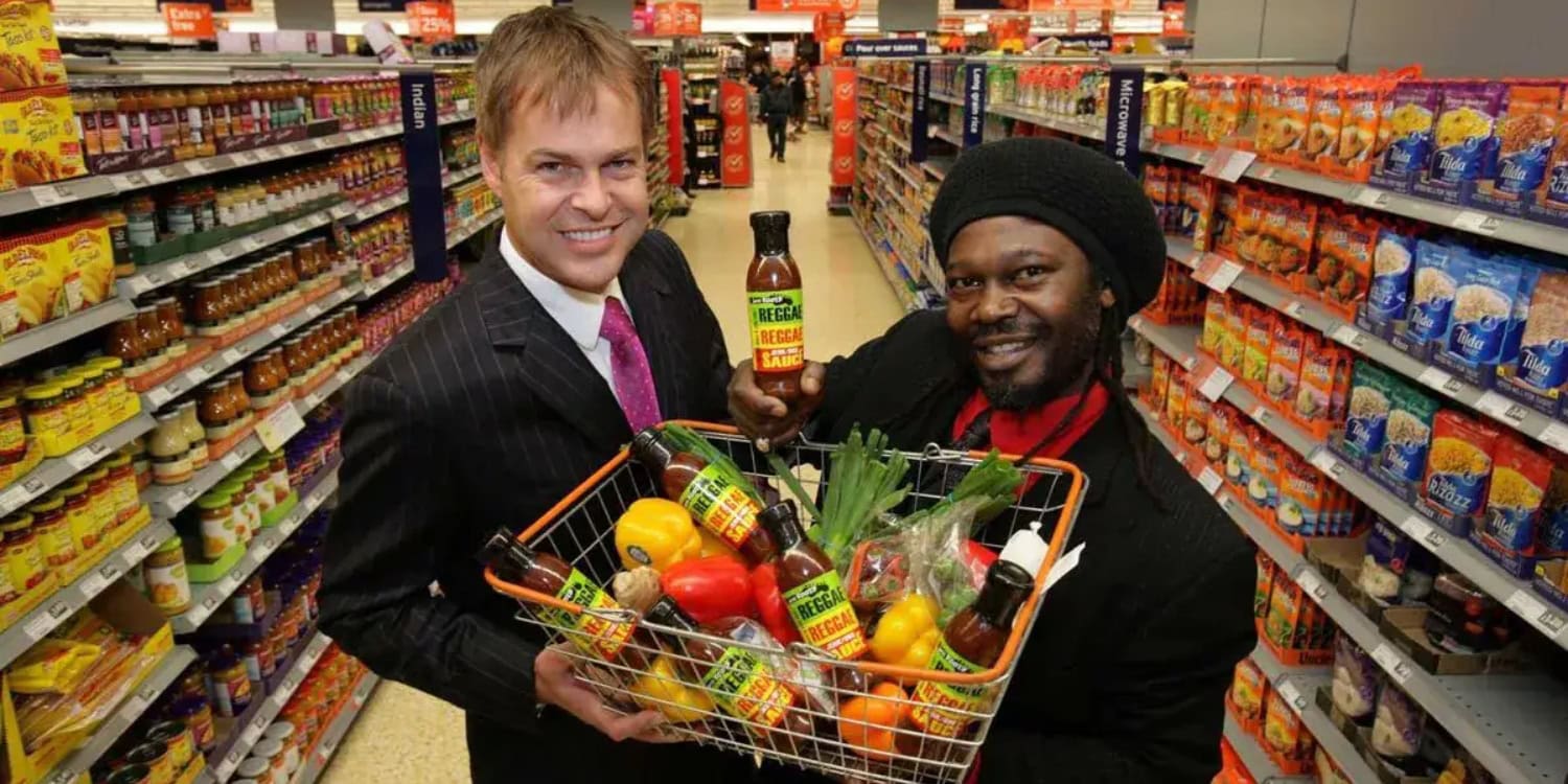Levi Roots and Peter Jones displaying Reggae Reggae Sauce in Sainsbury's supermarket