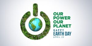 Earth Day 2025 banner set against a pale blue background, featuring a globe and a power icon covered in trees, symbolising sustainability. The theme 'Our Power, Our Planet - Happy Earth Day April 22; is displayed.