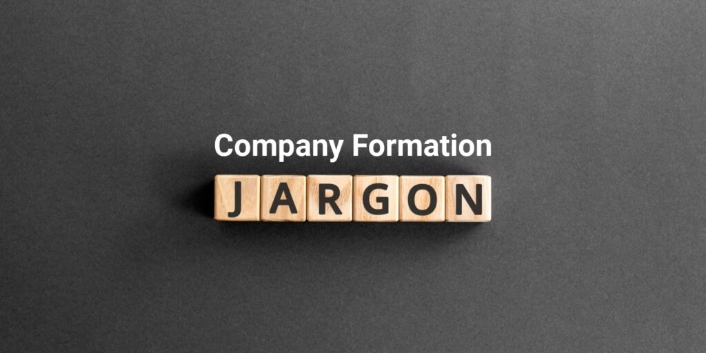 The words 'Company Formation' in white font with wooden blocks below, with letters spelling 'JARGON' against a gray background.