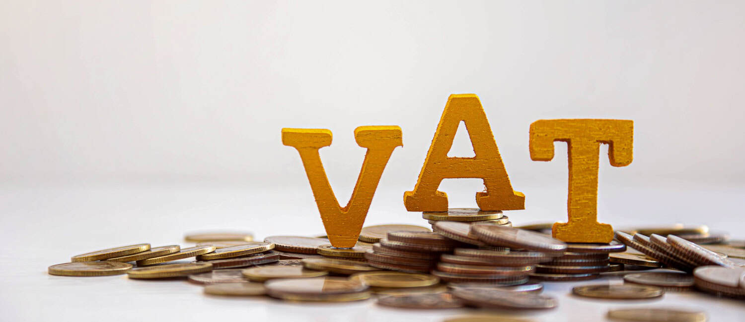 VAT concept, with the letters VAT sitting on coins.