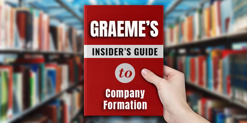 Person holding a red book titled "Graeme’s Insider’s Guide to Company Formation" in a library, referencing limited company setup