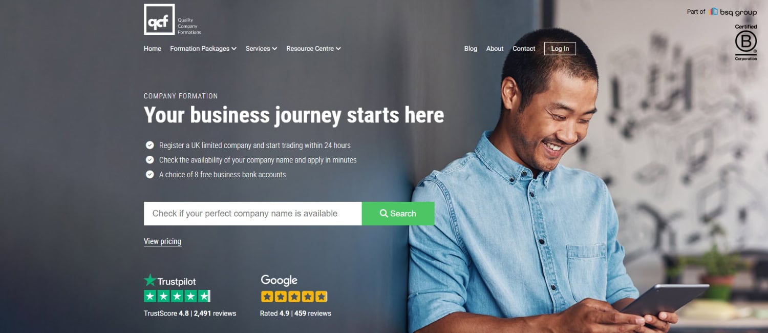 Quality Company Formations website homepage featuring a man smiling while using a tablet, with information on starting a UK limited company.
