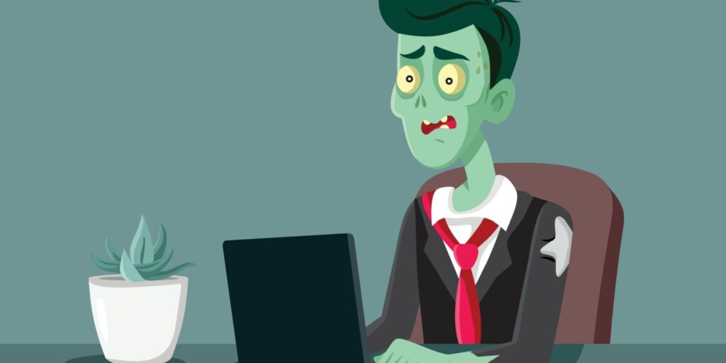 Illustration of a stressed cartoon zombie businessman in a tattered suit, sitting at a desk with a laptop and plant, symbolising a "zombie company" stuck in survival mode