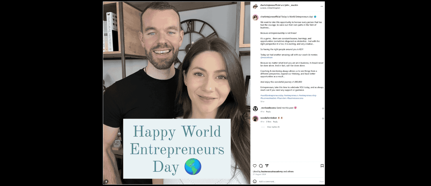 A smiling couple stands together, holding a sign that says "Happy World Entrepreneurs' Day" with a globe icon. Bookshelves are visible in the background.