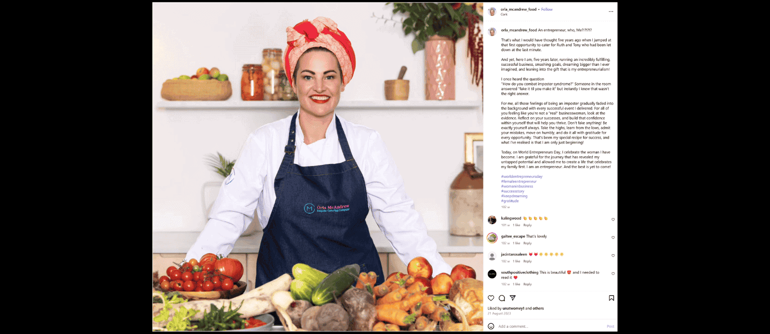 An Instagram post showing a smiling female chef in a white shirt and dark blue apron stands behind a table overflowing with fresh vegetables and fruits.