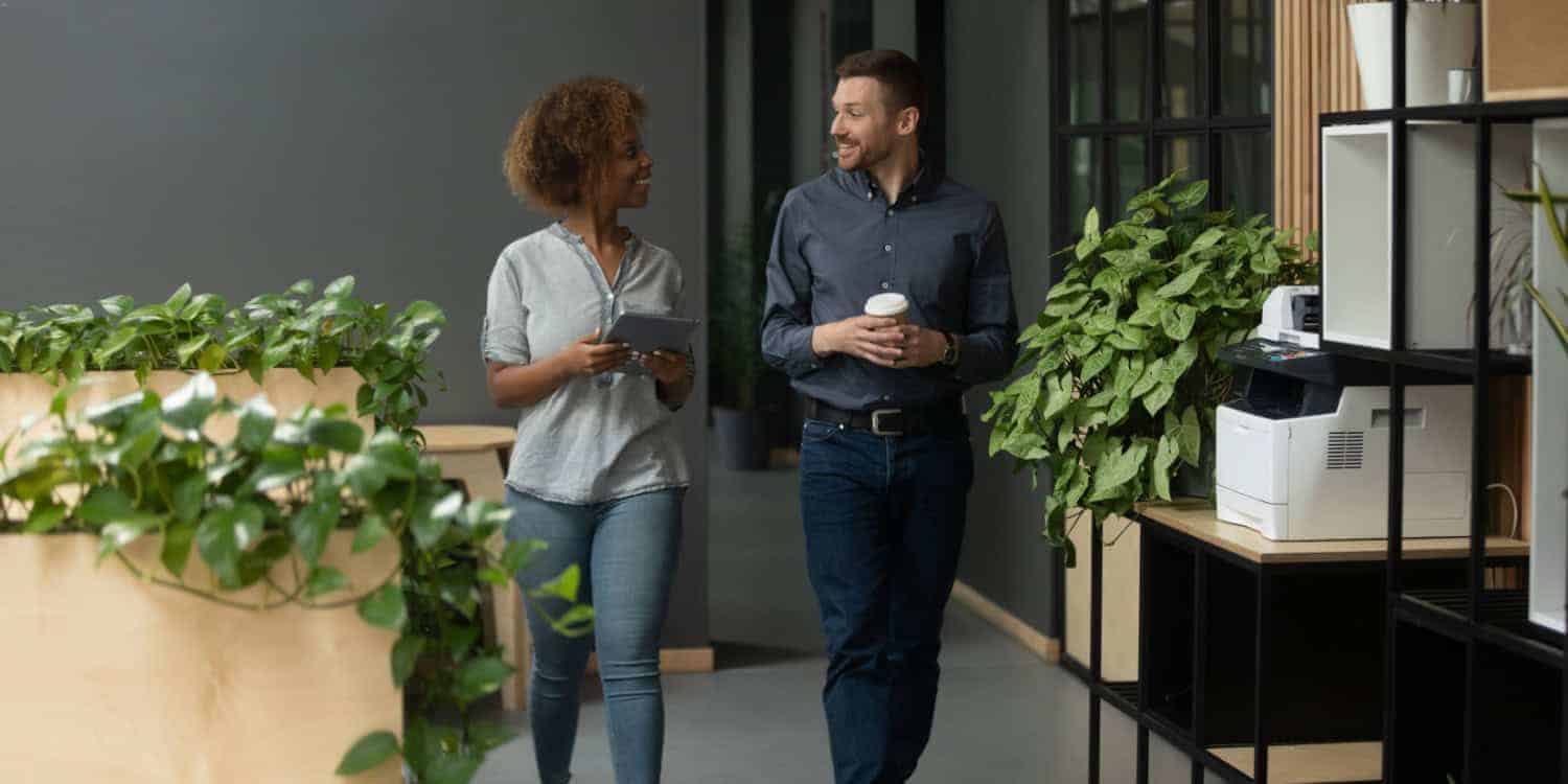 Woman networking with male colleague in the workplace