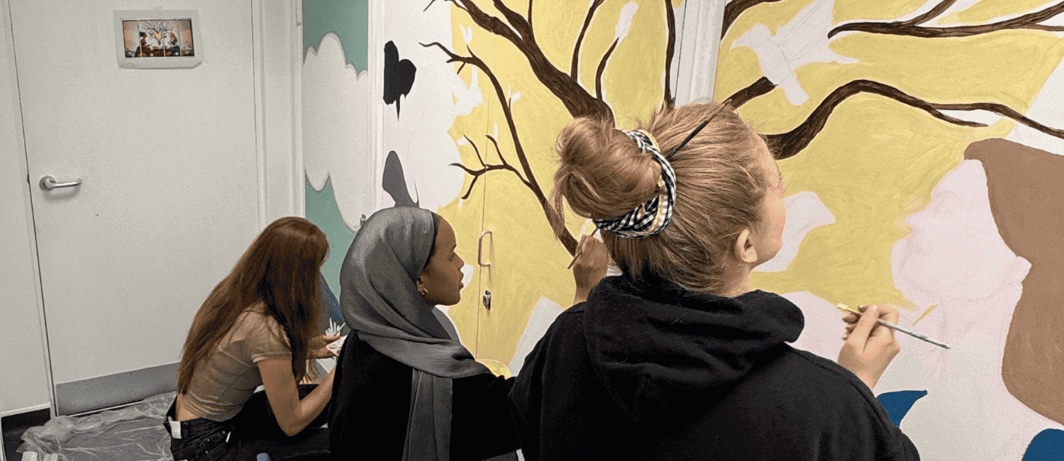 1st Formations employees painting a mural at the Baytree Centre