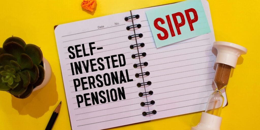 Notebook with the words Self-Invested Personal Pension (SIPP) on yellow background