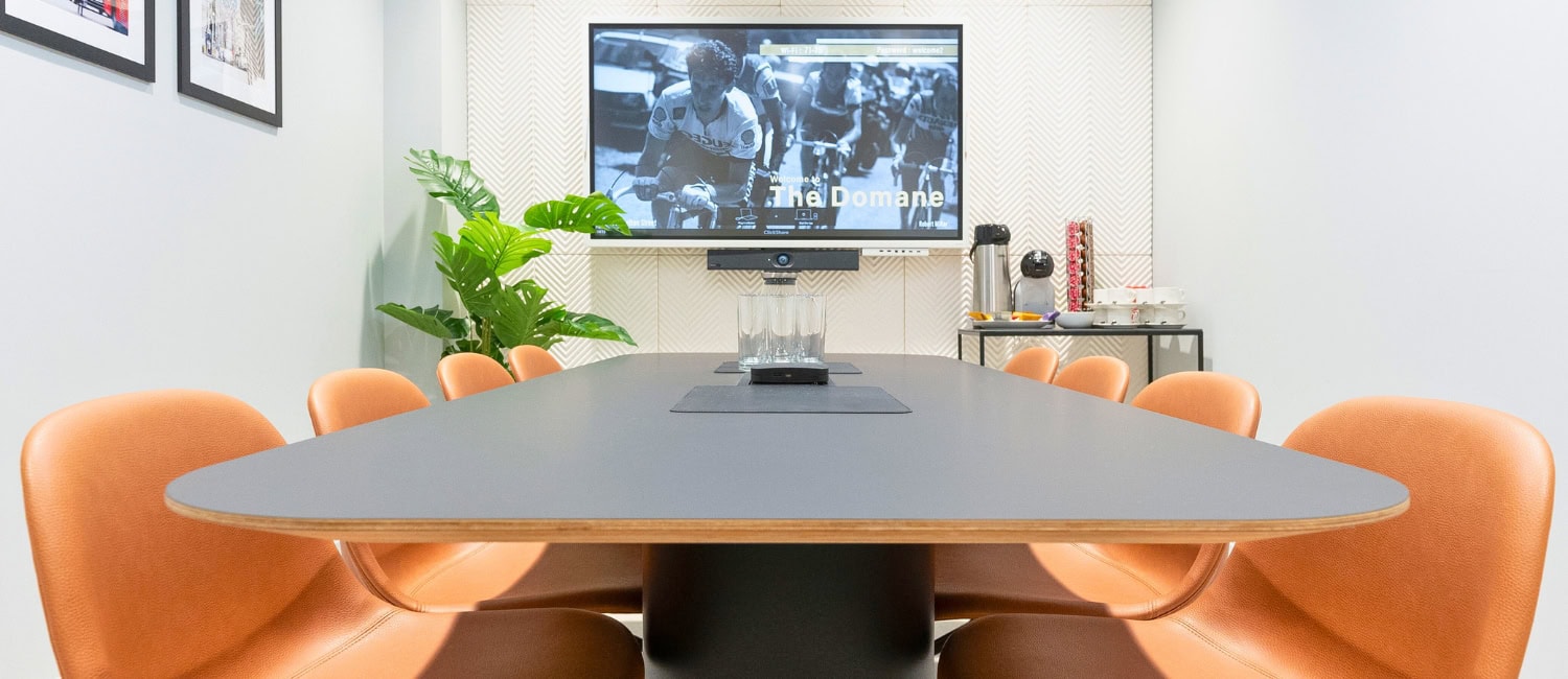 Modern business meeting room at 71–75 Shelton Street with round table, conference chairs and screen