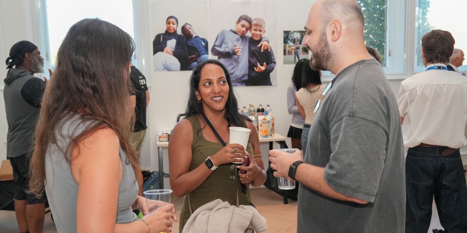 The 1st Formations team speaking to the attendees at Young Camden Foundation's annual summer party.